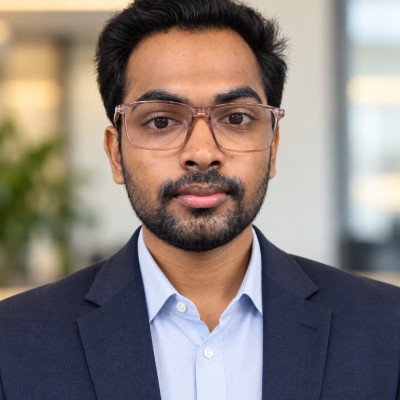 Praneeth Dathu wearing a navy jacket and glasses